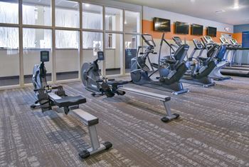 Row machines and cardio equipment in the fitness center,